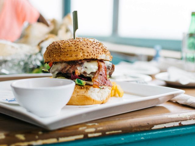 juicy-burger-in-a-vibrant-colorful-interior-FX2VZ6W.jpg